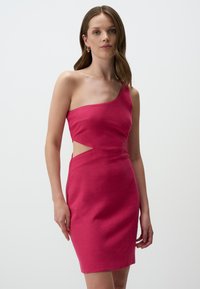 Robe fuchsia à une épaule avec une silhouette moulante, une découpe sur le côté et une texture lisse. Design simple sans motifs ou accents supplémentaires.