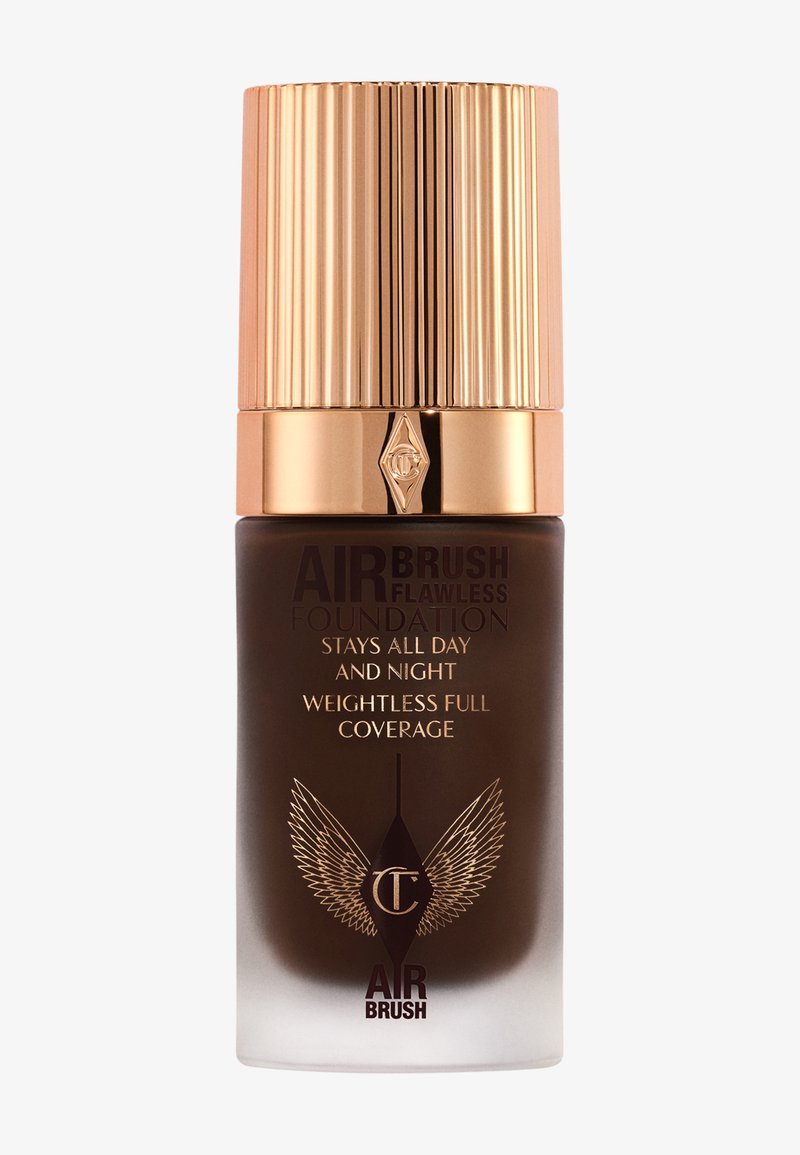 Brown glass bottle with a ribbed gold cap. Features "Airbrush Flawless Foundation" text and wing graphic. Sleek, modern design.