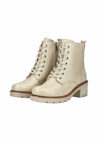 Bottines en cuir beige avec un bout rond, un laçage à l'avant et une fermeture éclair sur le côté. Elles présentent un talon chunky et une semelle texturée pour une meilleure adhérence.