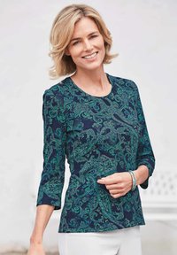 Marineblaues Langarmoberteil mit grünem Paisleymuster. Mit Rundhalsausschnitt und taillierter Silhouette. Weicher Stoff mit glatter Textur.