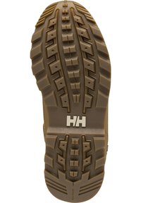 Suela de goma marrón con profundos surcos, que presenta un logo plateado "HH", un patrón texturizado y ranuras para agarre y tracción.