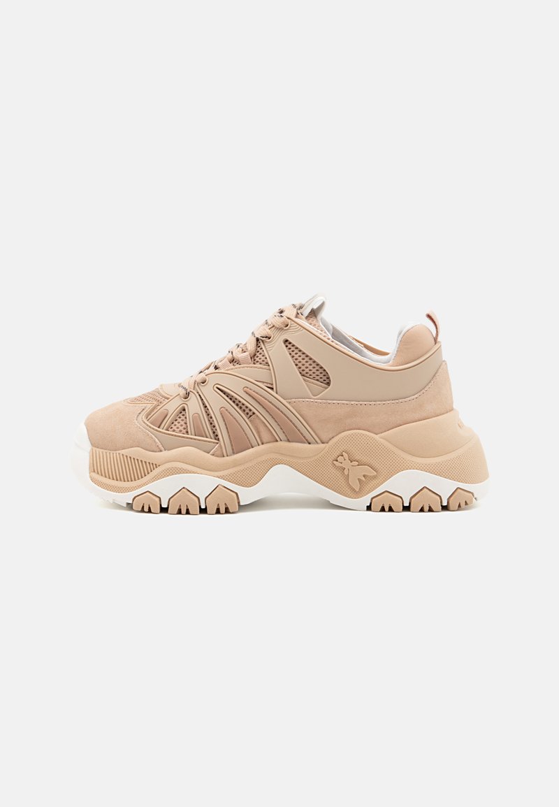 Scarpe da ginnastica beige con tomaia in rete e suede, suola bianca testurizzata, design ondulato unico e dettaglio di branding minimalista sul lato.