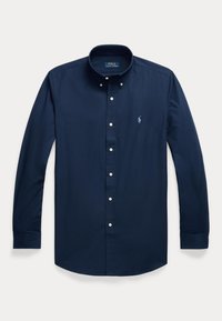 Tumesinine pikkade varrukatega särgike valgete nööpide ja vasakul rinnal väikese helesinise Polo Ralph Laureni logoga.