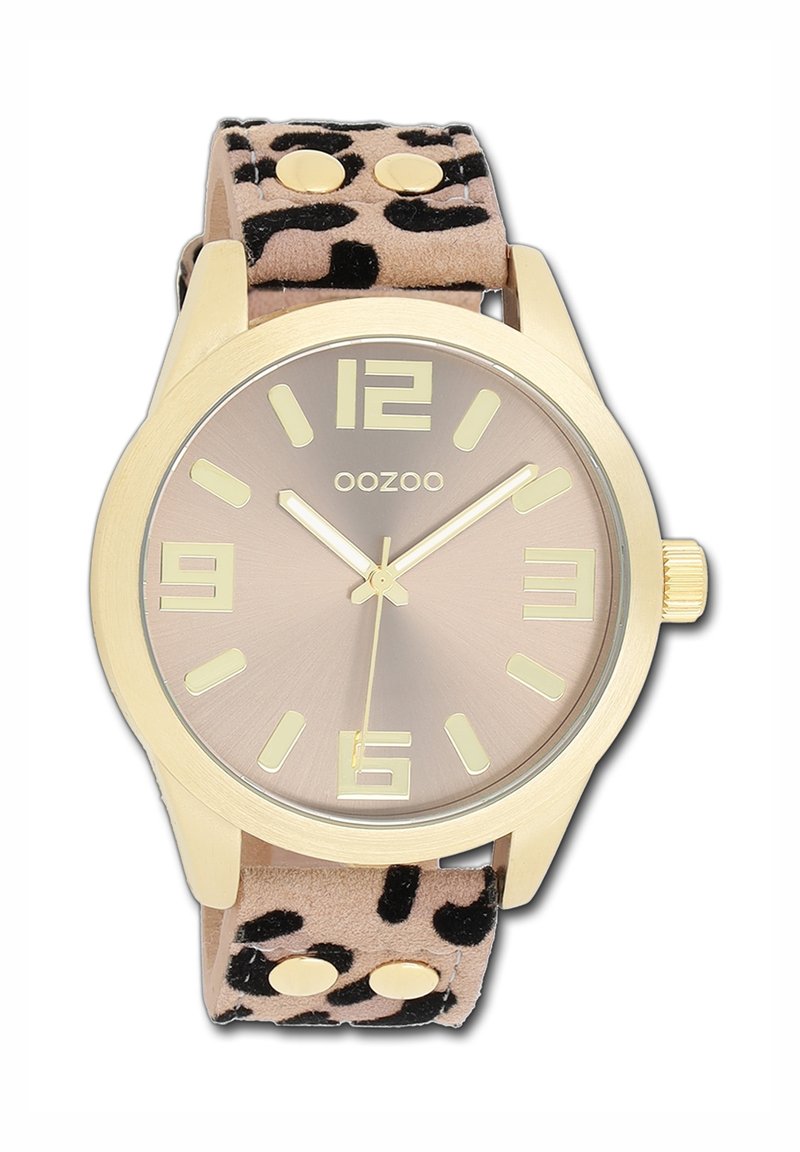 Round gold watch with a brown gradient face, featuring large hour markers. Soft beige strap with black leopard print and metal accents.