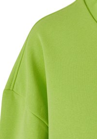 Felpa verde lime con tessuto morbido e testurizzato, dal fit rilassato e maniche scese per un look casual.
