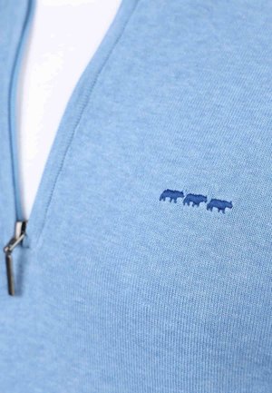 Sweatshirt zippé bleu clair avec une texture lisse, arbore trois motifs d'animaux brodés en bleu foncé sur le côté gauche de la poitrine.