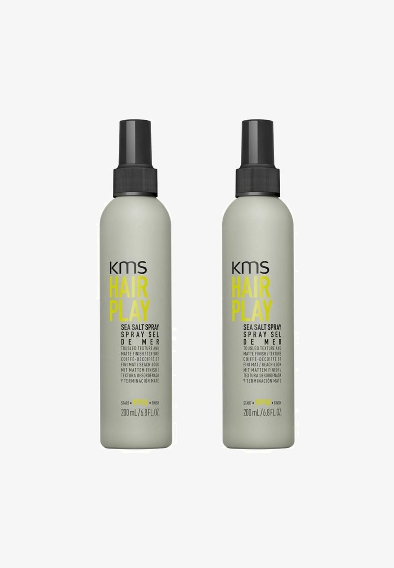Two bottles of KMS Hair Play Sea Salt Spray, 200 mL each. Gray bottles with black pumps and bright yellow text. Matte finish, ergonomic design.