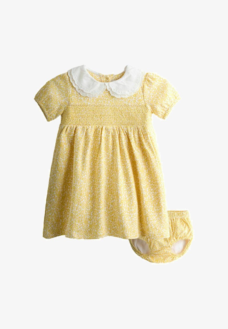 Vestitino giallo a fiori per bebè con colletto Peter Pan bianco smerlato, maniche corte a sbuffo, corpetto arricciato e mutandine abbinate.