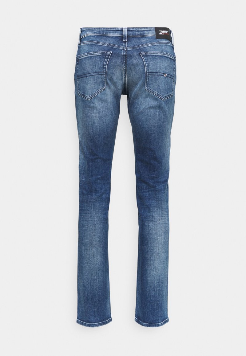 Niebieskie dżinsy slim fit z tylnymi kieszeniami, wyblakłymi detalami i czarną metką Tommy Jeans na pasku.