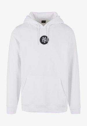 White hooded sweatshirt with a front pouch pocket, featuring a black circular patch with "NY" logo at the center. Soft cotton blend material.