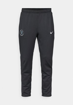 Mustad mustad spordipüksid pehmest kangast, millel on elastne vöökoht, küljetaskud ja valge Nike logo vasakul jalal.