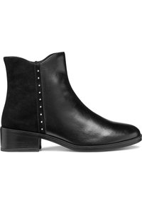 Black ankle boot made of smooth leather with a suede panel. Features decorative silver studs along the side and a low stacked heel.