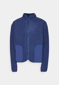Navy fleecejacka med kontrasterande blå paneler, dragkedjestängning, hög krage och svart logotyp på vänster bröst. Mjuk textur och avslappnad passform.