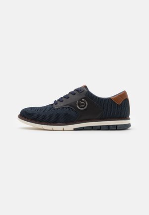 Marineblaues Mesh-Sneaker mit schwarzen synthetischen Akzenten und braunem Lederfersenbereich. Mit abgerundetem Zehenbereich, Schnürdesign und weißer strukturierter Sohle.