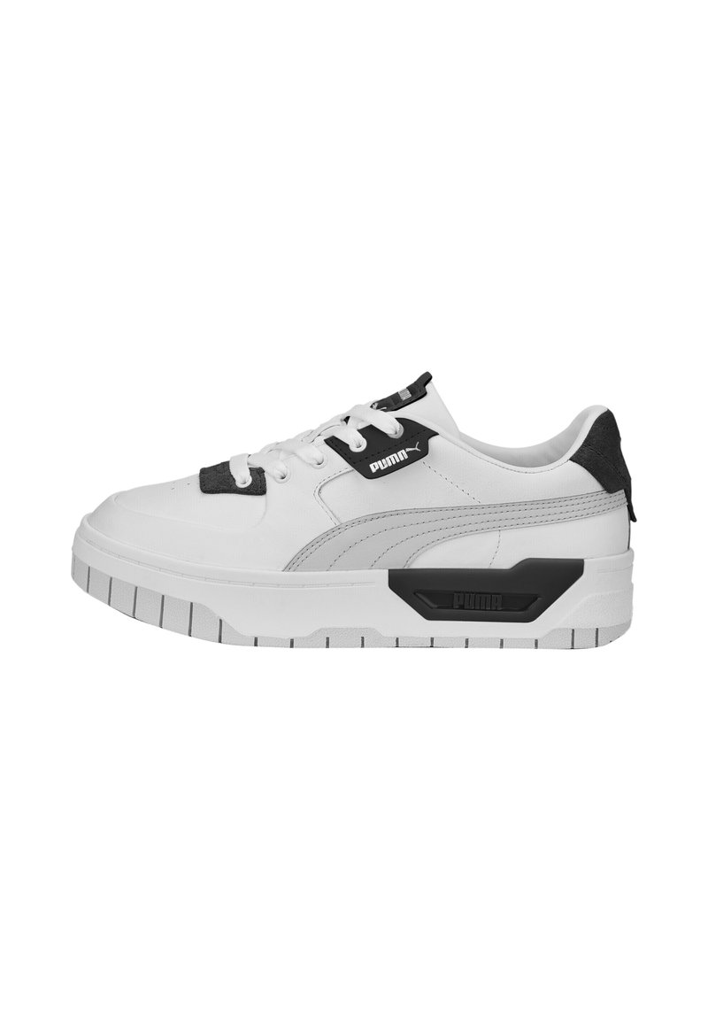 Baskets Puma blanches et noires avec semelle épaisse, design à lacets et logo Puma sur le côté et la languette.