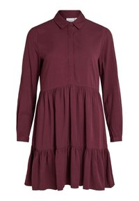 Burgunderfärgad långärmad klänning med kragkrage, knappstängning fram och skiktad volangnederdel. Tillverkad av mjukt tyg med en slät yta.