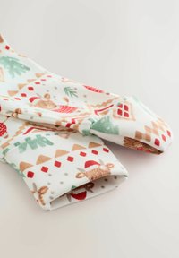 Mustriga kangas, kus on punane, roheline ja beež, sealhulgas puud, majad ja karud Santa mütsidega. Pehme ja paindlik materjal.