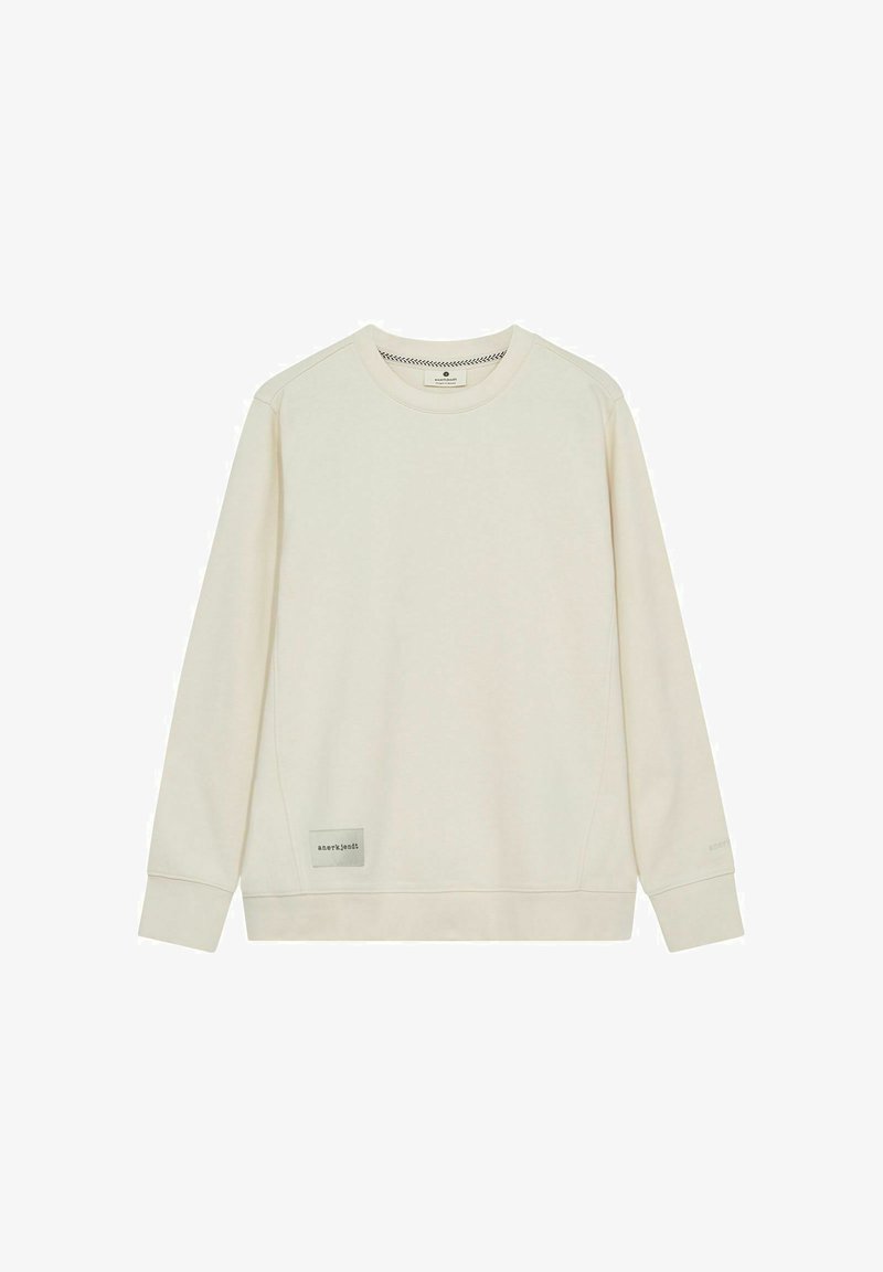 Light beige sweatshirt with long sleeves, rounded neckline, textured fabric, and logo patch on the lower side. Simple, minimalist design.