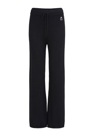 Pantalon large en maille noire avec taille côtelée et cordon de serrage, présentant un petit logo blanc avec un palmier sur la hanche gauche.