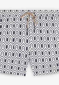 Men’s swim shorts with black and white zigzag pattern featuring small skull details and a beige drawstring at the waist.
