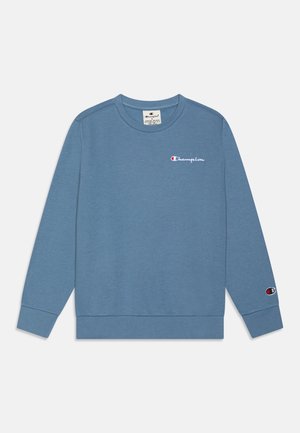 Niebieska bluza Champion z długim rękawem, z okrągłym dekoltem, małe logo na lewej piersi oraz naszywka z logo na mankiecie lewej rękawicy.