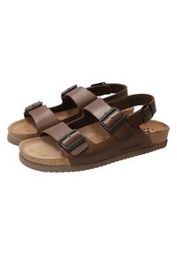 Sandales en cuir marron avec deux courroies réglables, boucles en métal noir et une semelle en liège contournée. Logo de la marque sur le côté.
