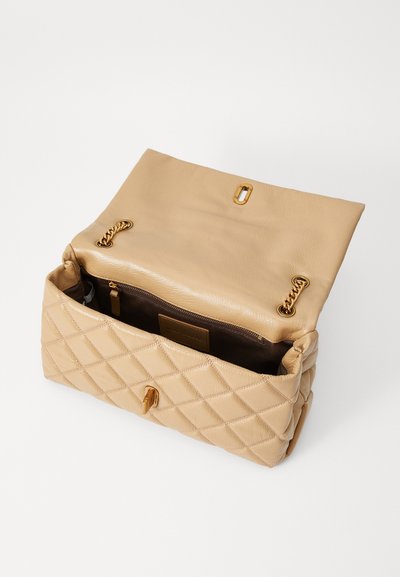 Quilted beige leather handbag with gold-toned hardware, featuring a top flap and an interior pocket, showcasing a soft texture and clean design.