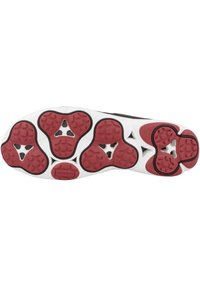 Soletta della scarpa con parte superiore nera, intersuola bianca e elementi in gomma rossa. Suole profonde e un design unico con motivi esagonali.