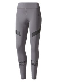 Šedé sportovní legíny s vysokým pasem, ozdobené černými geometrickými akcenty a proužkovaným vzorem u lemu. Vyrobeno z elastického materiálu.