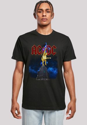 Black cotton t-shirt featuring a vibrant graphic of a golden guitarist and "AC/DC" text in red, set against a starry background.