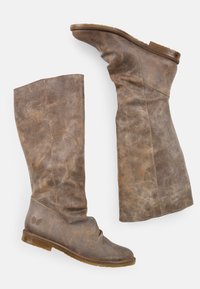 Bottes en cuir marron montantes avec un design légèrement décontracté, bout rond et texture lisse ; présente un petit accent logo sur le côté.