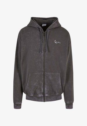 Tumehall halli, pehmeast ja tekstureeritud kangast. Omab reguleeritavat kapuutsi, eesmine taskud ja diskreetne logo vasakul rinnal.