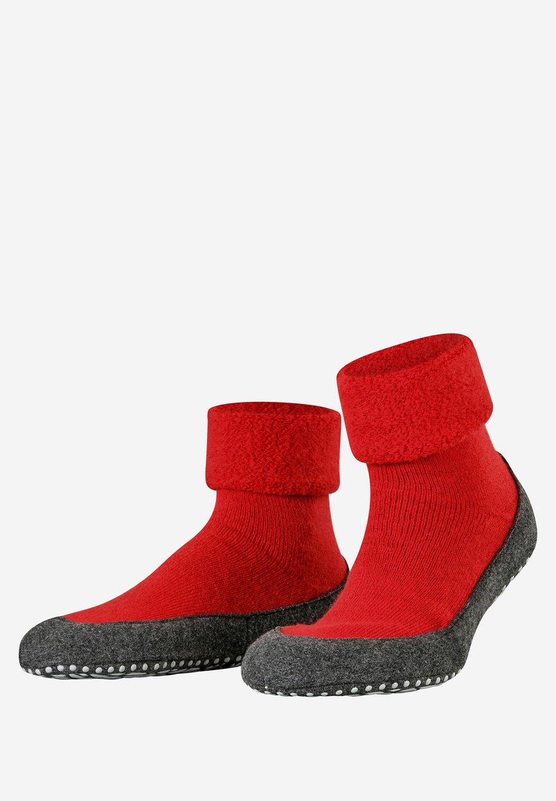 Κόκκινες μάλλινες κάλτσες με γκρι επένδυση από τσόχα στη σόλα, με ριμπ μανσέτα και αντίθετο κάτω τμήμα. Η σόλα διαθέτει λευκές καουτσούκ κουκκίδες για πρόσφυση.