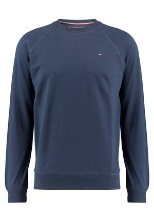 Granatowa bluza z długim rękawem i okrągłym dekoltem, z małym logo Tommy Hilfiger na piersi oraz ściągaczami na rękawach i na dole.