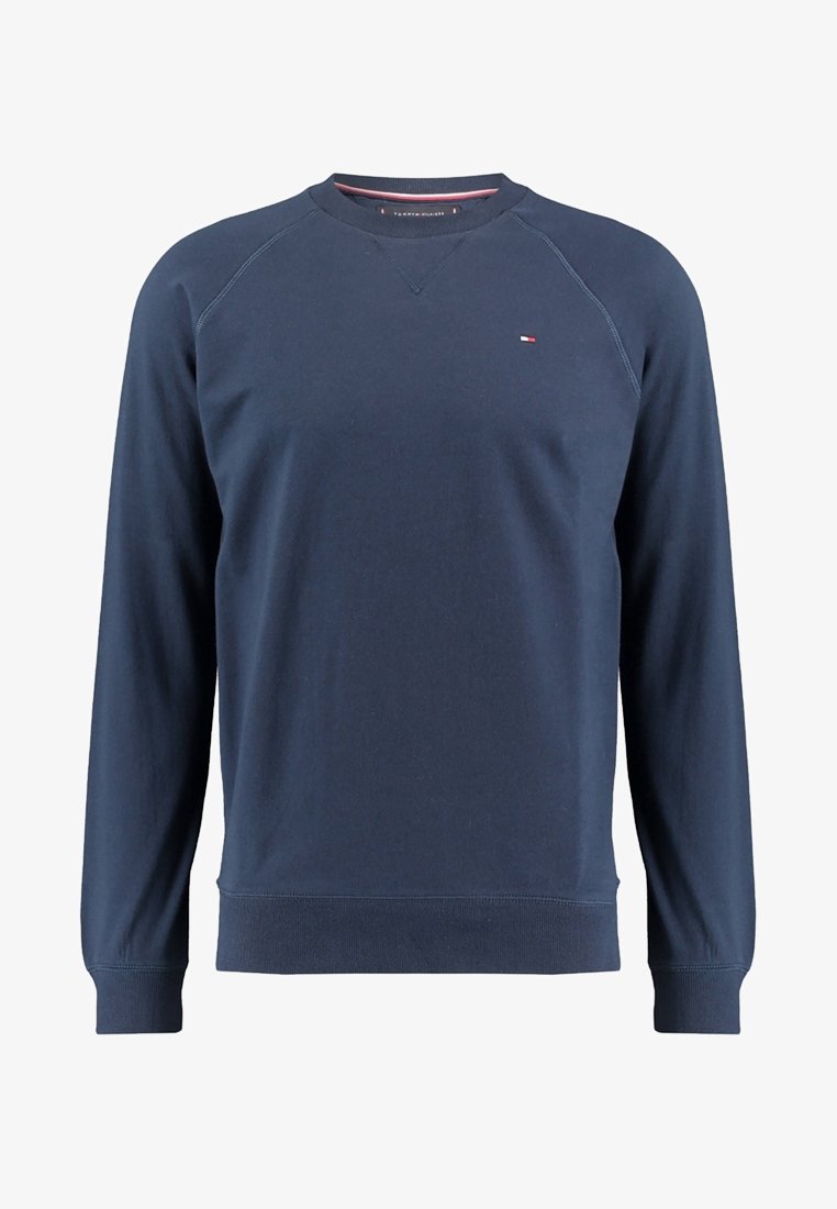 Sweat-shirt bleu marine à manches longues avec col rond, petit logo Tommy Hilfiger sur la poitrine, poignets et bas côtelés.