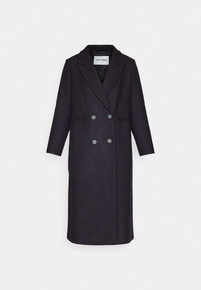 Black wool blend coat featuring a double-breasted front, wide lapels, long sleeves, and two front pockets. Clean, tailored design.