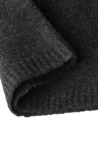 Dark gray woolen fabric, soft and textured, with a folded edge showcasing a ribbed design. Visible fibers add depth and warmth.