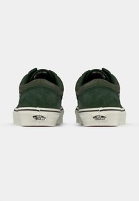 Green suede sneakers with white rubber soles, featuring a black stripe and heel tab. Includes Vans logo on the heel.