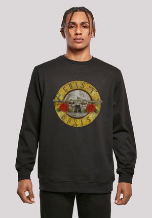 Schwarzer Hoodie mit rundem Grafikdesign, featuring einem gelben kreisförmigen Rand, einem grauen inneren Kreis und roten Rosen, beschriftet mit "GUNS N' ROSES".