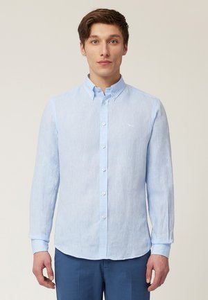 Light blue long-sleeve button-up shirt made of textured fabric, featuring a classic collar, front buttons, and a small logo on the chest.