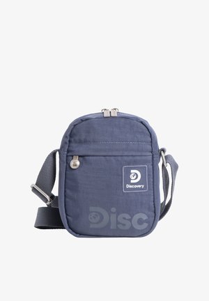 Kleine Schultertasche in Marineblau mit verstellbarem Riemen, vordere Reißverschlusstasche und Discovery-Logoaufnäher auf weißem Hintergrund.