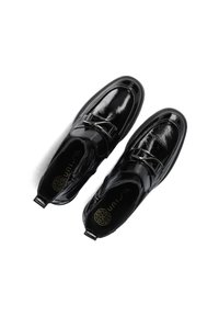 Black patent leather loafers with a rounded toe, metallic buckle accent, and textured insole featuring branding. Smooth, glossy finish.