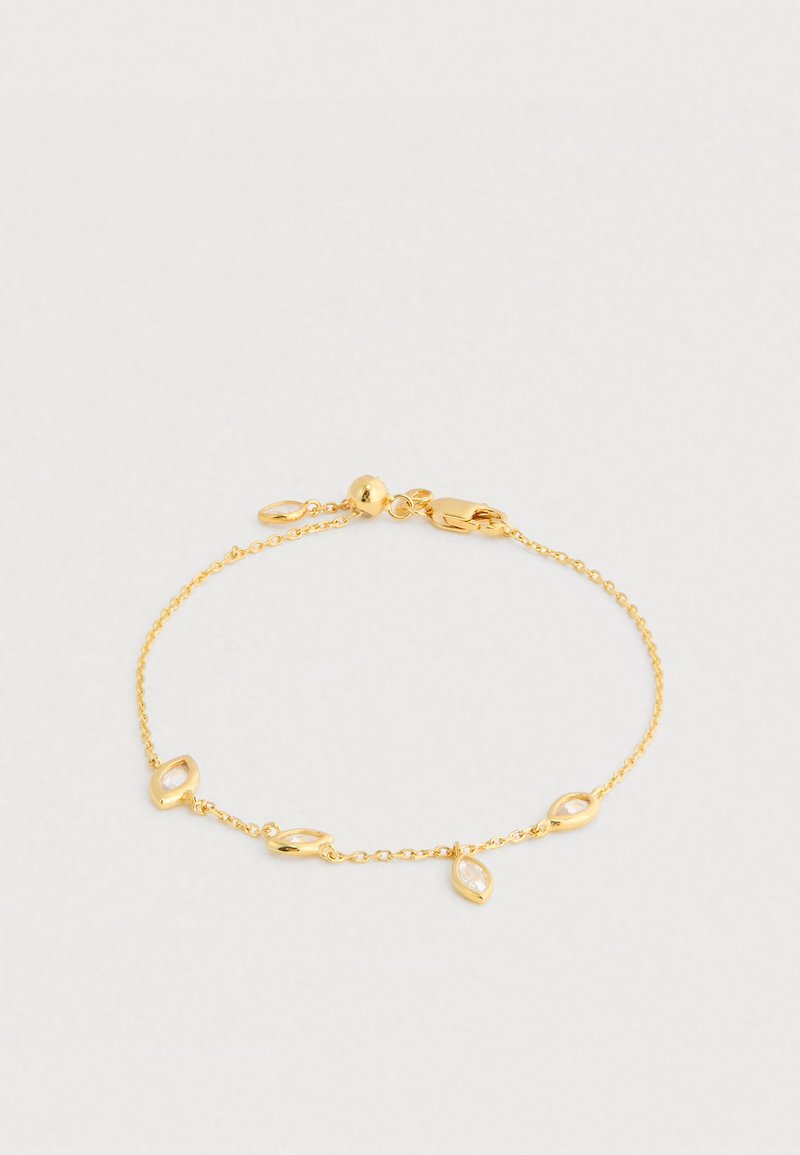 Zlata zapestnica z verižico z akcenti v obliki markize z prozornimi središči. Nežni članki z zaponko za zapiranje in nastavljivo dolžino.