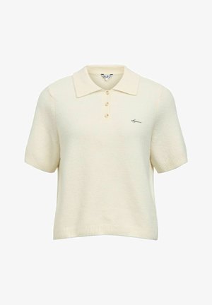 Kreemikas polo-särk lühikeste varrukatega, tekstuurse koega, kolmega nööbiga ja vasakul pool väike logoga tikand.