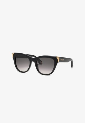 Lunettes de soleil noires forme œil de chat avec verres gris dégradés et accents dorés sur les coins supérieurs et les branches, marquées "roberto cavalli" sur le côté.
