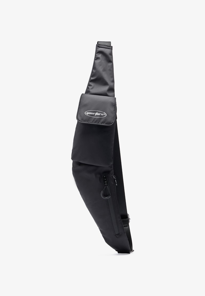 Black sling bag made from nylon, featuring a zippered pocket, snap closure flap, and adjustable strap for ergonomic wear.