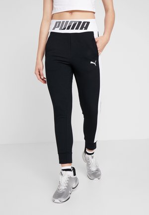 Pantalons de sport noirs avec des panneaux latéraux blancs, arborant un logo "PUMA" bien visible sur la taille et un petit logo sur la cuisse.