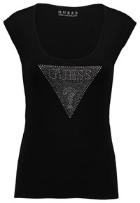 Top noir sans manches avec un col rond, présentant un motif triangulaire en strass et l'inscription "GUESS" au centre. Tissu doux et extensible.