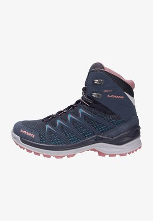 High-top hiking boots featuring a navy blue and pink color scheme, constructed with Gore-Tex material and textured mesh for breathability.