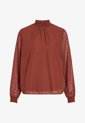 Rdzawobrunatna bluzka z wysokim marszczonym kołnierzem, długimi przezroczystymi rękawami i wzorem w zygzak. Luźny krój z elastycznymi mankietami.